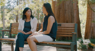 two women talking on bench