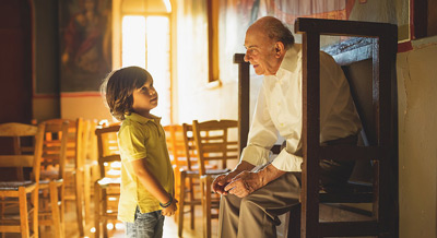 man talking with young grandchild