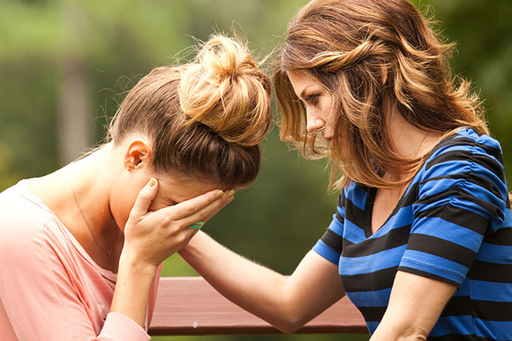 woman comforting woman